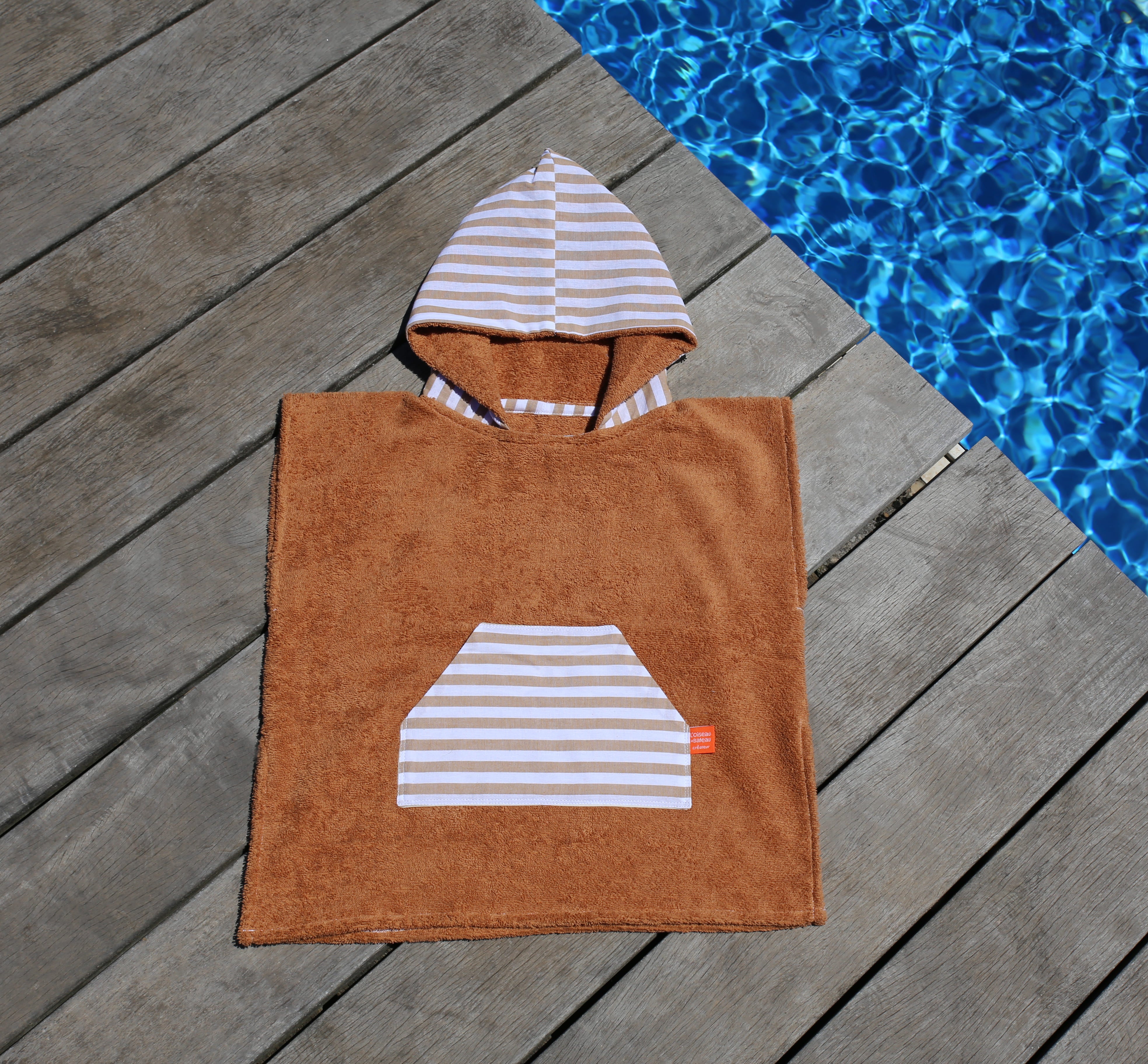 Cape de bain bebe, cape de bain enfant, cape de bain  personnalisee bebe, cape de bain personnalisee enfant,cadeau de naissance, cadeau de naissance personnalise, carre de bain bebe, carre de bain enfant, poncho de bain bebe, poncho de bain enfant, creation française, design français, marque française, l'oiseau bateau, poncho raye, poncho enfant surfeur, poncho cote ouest, made in france, fabrique en france, fabrication artisanale, poncho marron